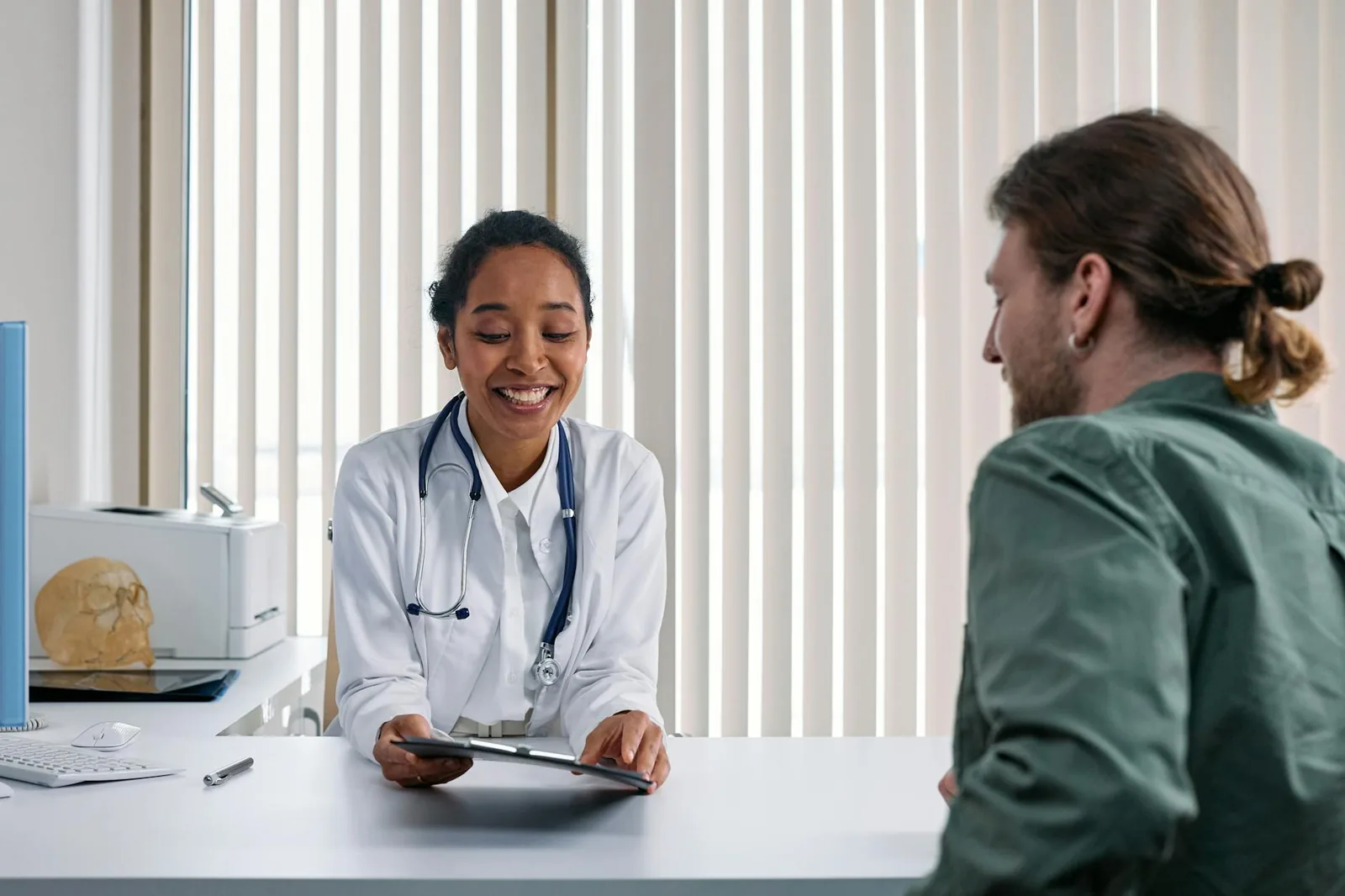 A doctor and patient engaging in a positive consultation in a bright clinic setting, the kind of conversation that anchors every treatment decision.