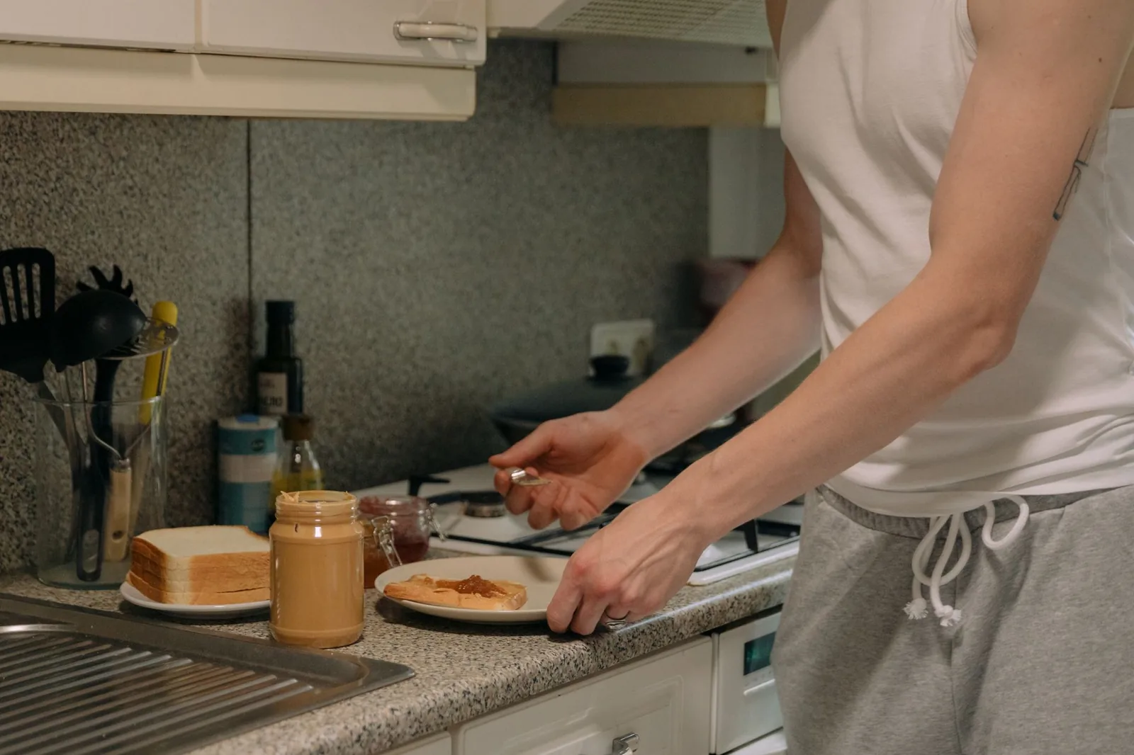 Person making a peanut butter and jelly sandwich